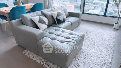 Stylish living room with modern leather sofa and city view, perfect for urban living.