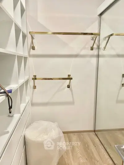 Spacious walk-in closet with elegant shelving and mirrored doors