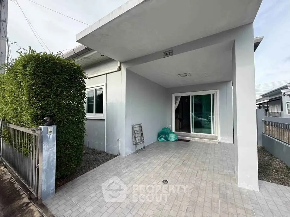 Charming single-story home with spacious driveway and modern exterior design.