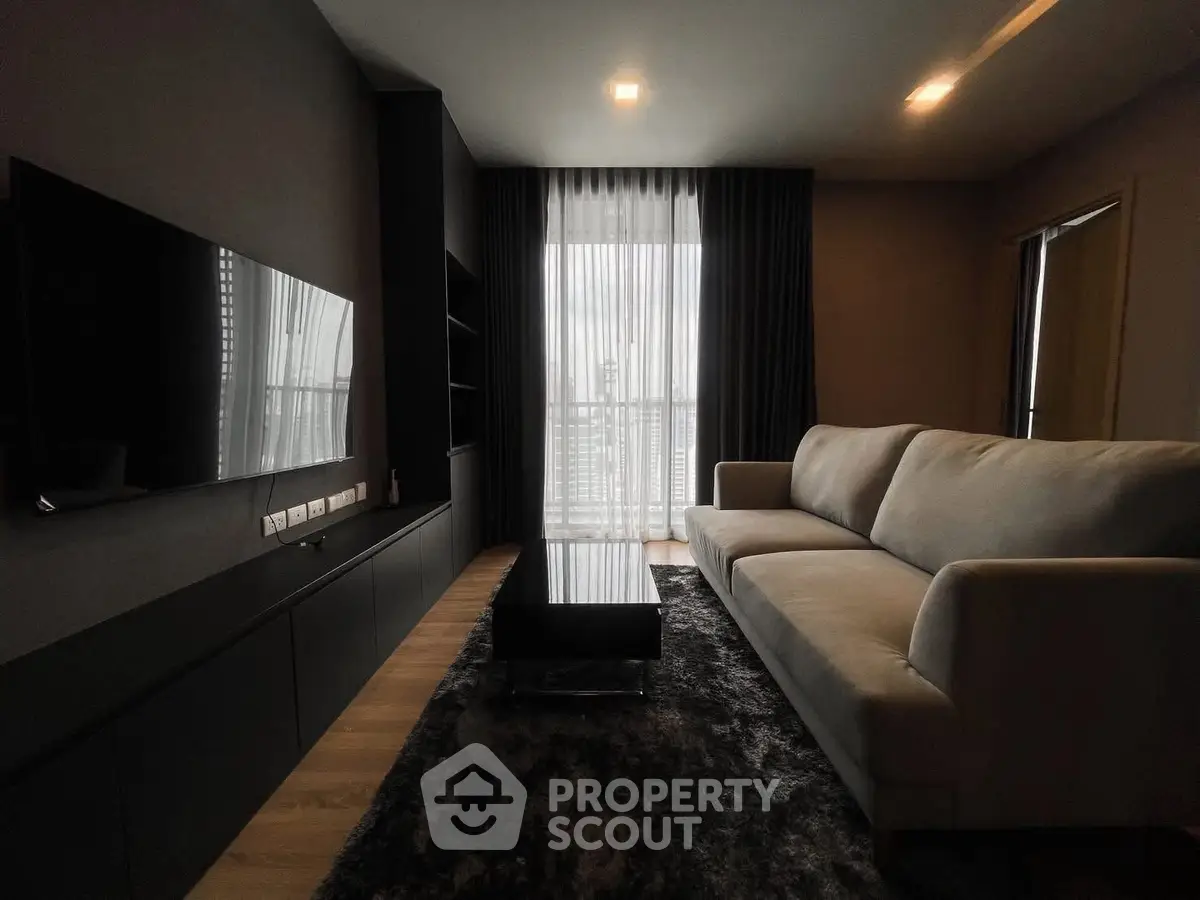 Modern living room with sleek furniture and large window view