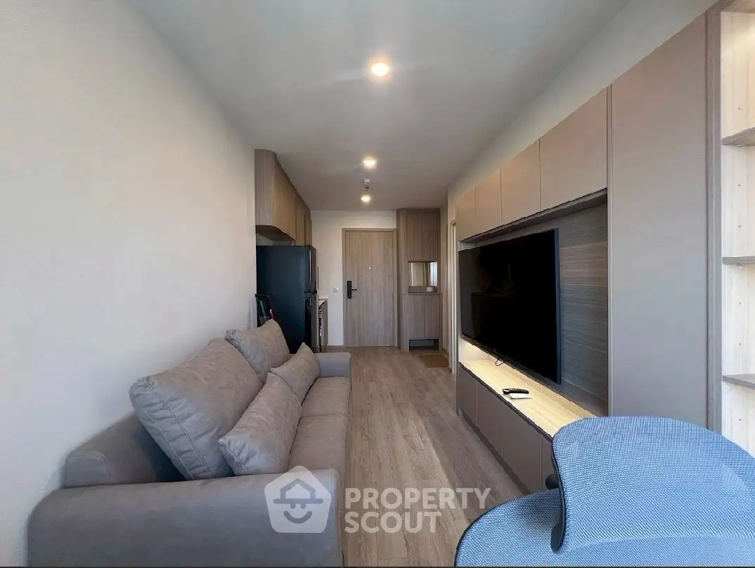 Modern living room with sleek design and comfortable seating in a contemporary apartment.