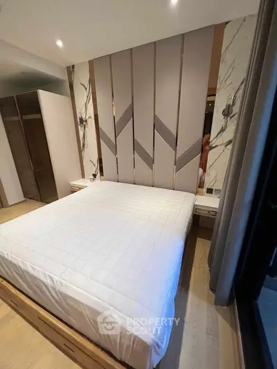 Luxurious bedroom with modern design and elegant headboard in upscale apartment.