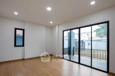 Spacious modern living room with large windows and wooden flooring