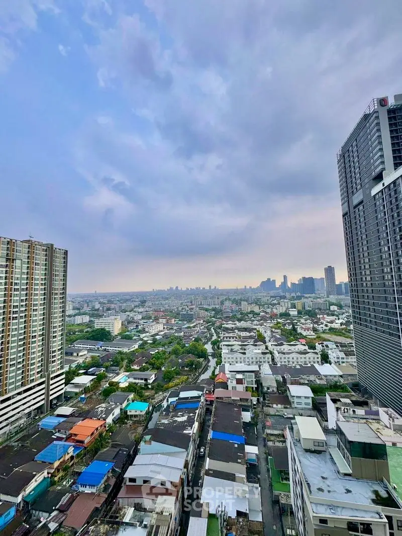 Stunning cityscape view from high-rise building showcasing urban skyline and residential areas.