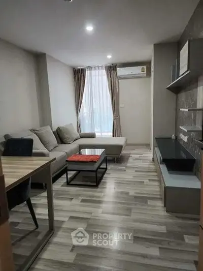 Modern living room with stylish furniture and natural light, perfect for relaxation and entertainment.