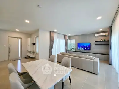 Modern open-plan living room with elegant dining area and stylish decor