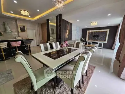 Luxurious dining room with elegant decor and modern lighting in a spacious open layout.