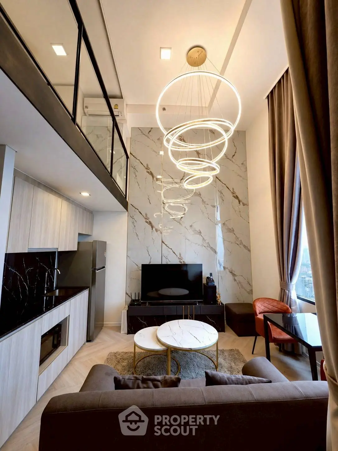 Luxurious modern living room with high ceilings, elegant lighting, and stylish decor in a contemporary apartment.