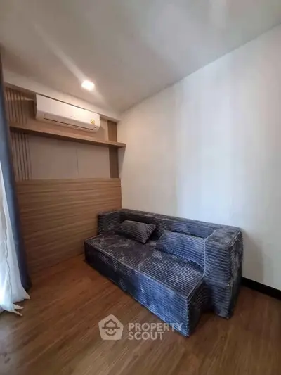Cozy living room with modern sofa and air conditioning in stylish apartment.