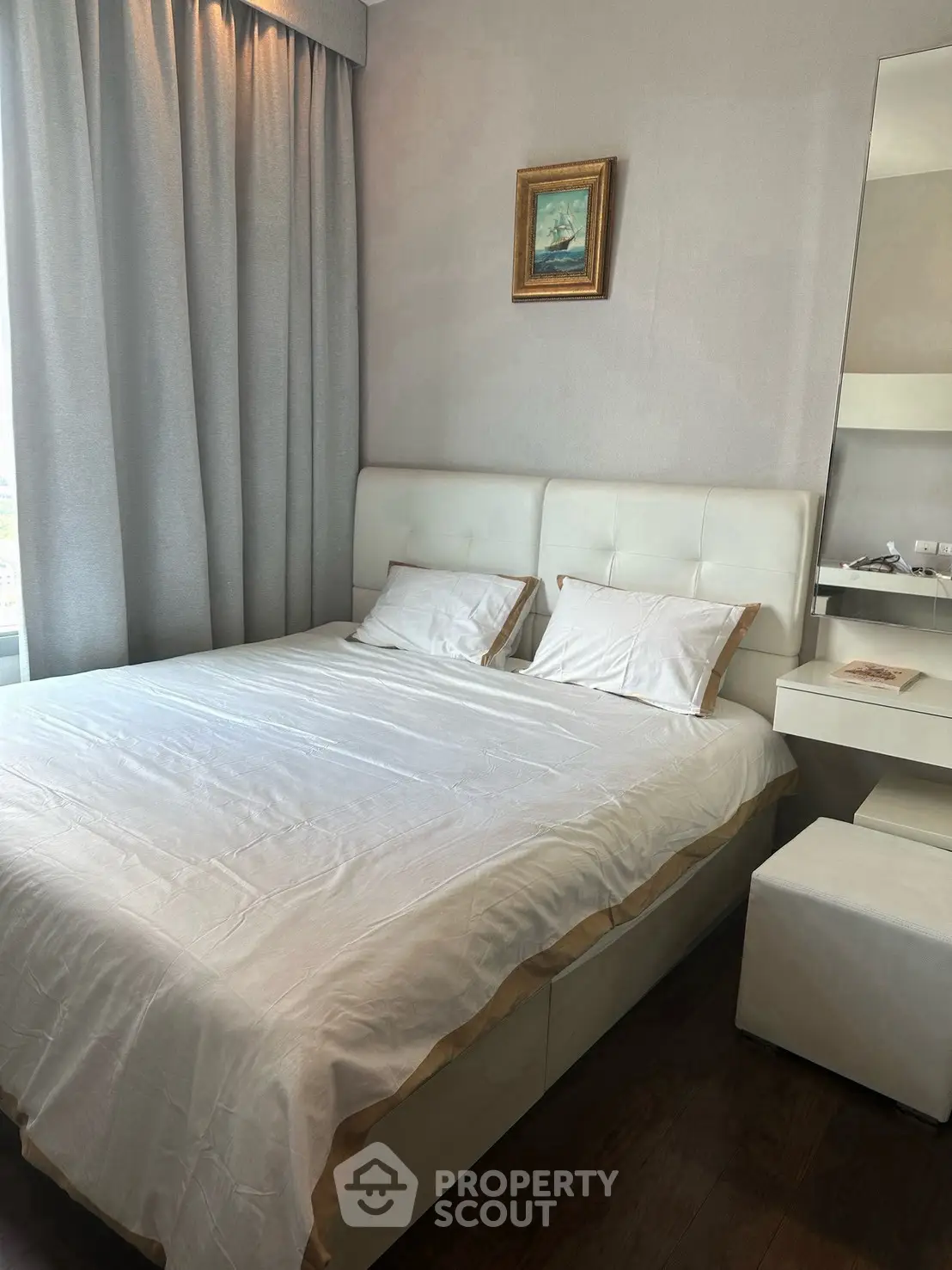 Elegant bedroom with plush bed, modern decor, and natural light for a cozy retreat.