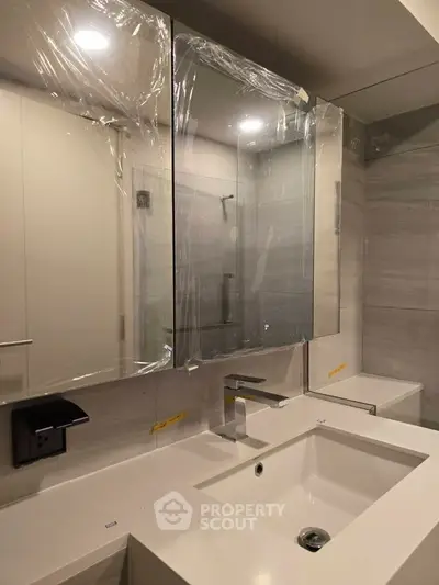Modern bathroom with sleek fixtures and large mirror