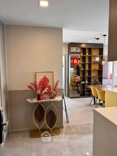Modern open-layout kitchen and dining area with stylish decor and elegant lighting.