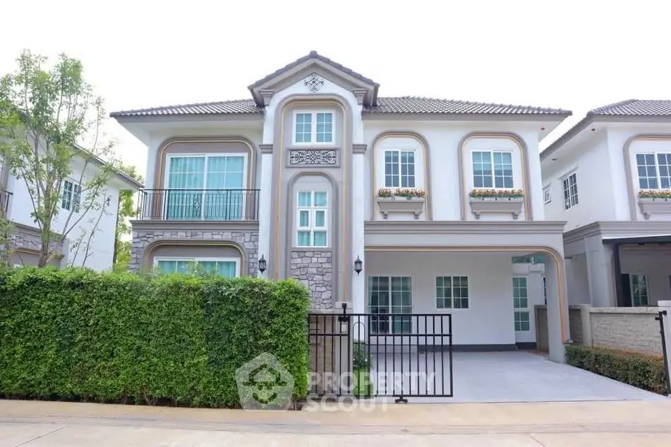Elegant two-story house with manicured garden and spacious driveway in a serene neighborhood.