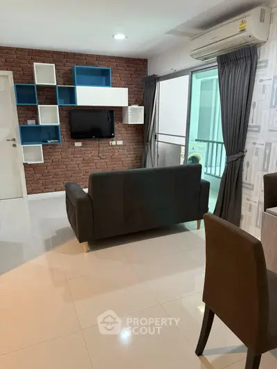 Modern living room with stylish brick wall and sleek furniture in a contemporary apartment.