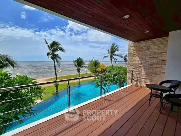 Stunning beachfront balcony with ocean view and lush greenery