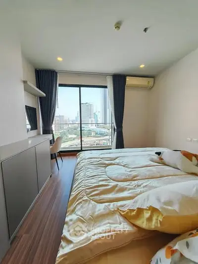 Modern bedroom with city view, featuring cozy bed and stylish decor.