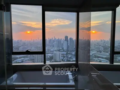 Luxurious bathroom with stunning city skyline view at sunset