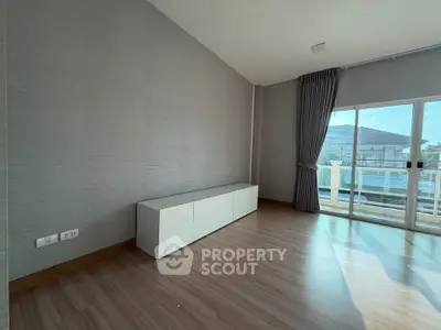Spacious living room with large windows and modern flooring