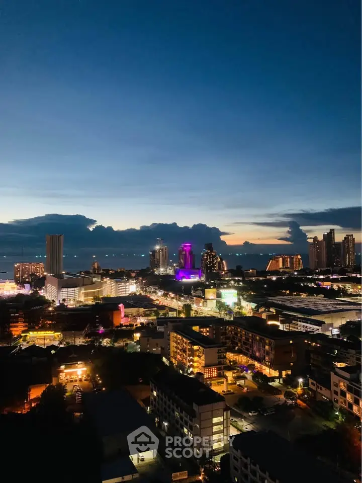 Stunning cityscape view at dusk showcasing vibrant skyline and illuminated buildings.