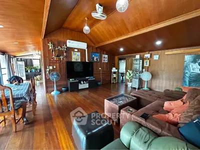 Spacious wooden living room with cozy seating and entertainment center