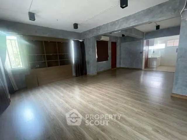 Spacious open-plan living area with modern flooring and ample natural light.