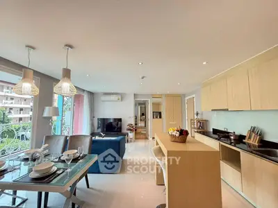 Modern open-plan living room and kitchen with stylish decor and natural light.