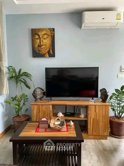 Stylish living room with modern TV setup and elegant decor, perfect for relaxation and entertainment.