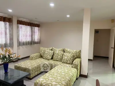 Spacious living room with stylish patterned sofa and elegant decor