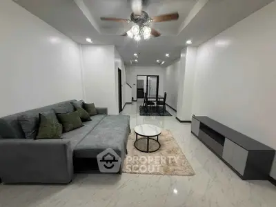 Spacious modern living room with elegant gray sofa and chic decor