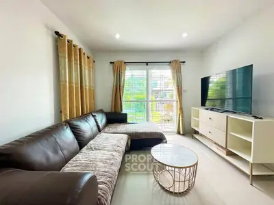 Spacious living room with modern decor and large TV, perfect for relaxation.
