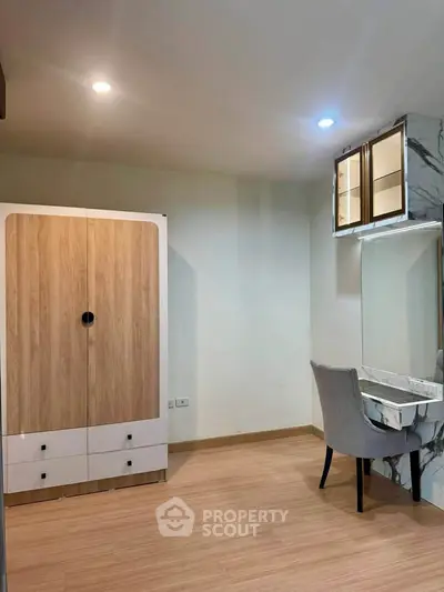 Modern bedroom with stylish wardrobe and elegant vanity in a cozy apartment.
