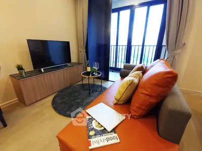Modern living room with stylish furniture and balcony view, perfect for urban living.