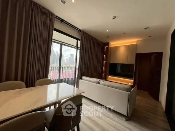 Modern living room with elegant dining area and city view balcony