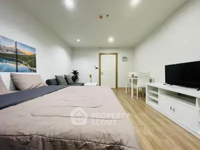 Modern bedroom with cozy decor and sleek furniture, featuring a comfortable bed and stylish TV setup.