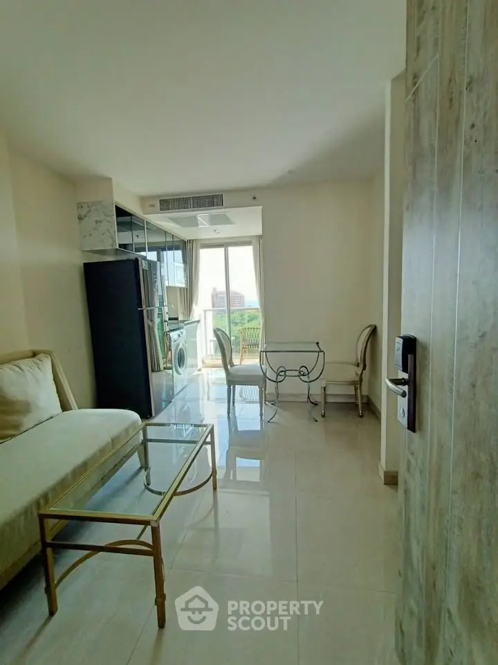 Bright living room with modern furniture and large windows offering a scenic view.