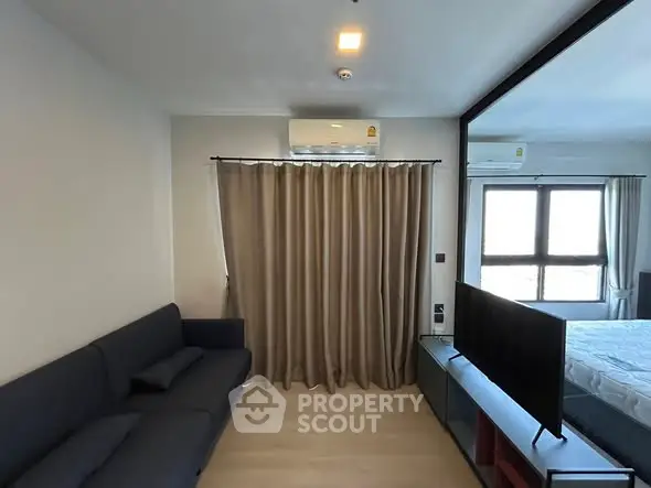 Modern living room with sleek furniture and large window for natural light