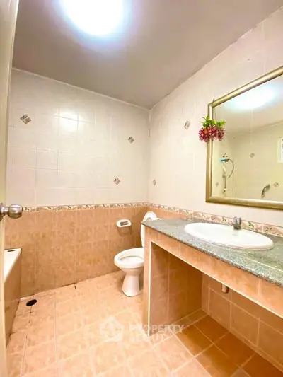 Spacious bathroom with modern fixtures and elegant tile design