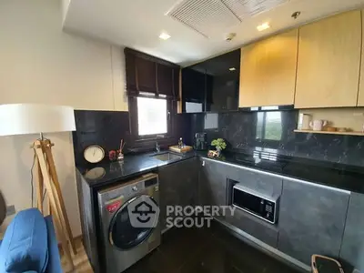 Modern kitchen with sleek black countertops and built-in appliances