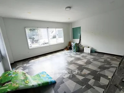 Spacious unfurnished room with large window and tiled floor, ideal for customization.