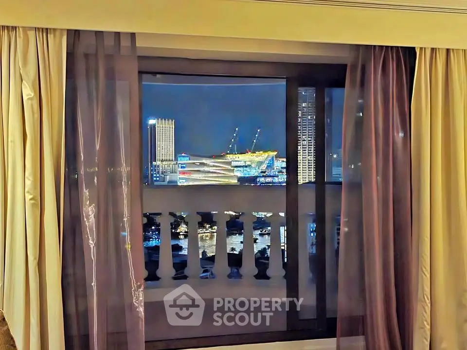 Stunning night cityscape view from a luxurious apartment window with elegant curtains.