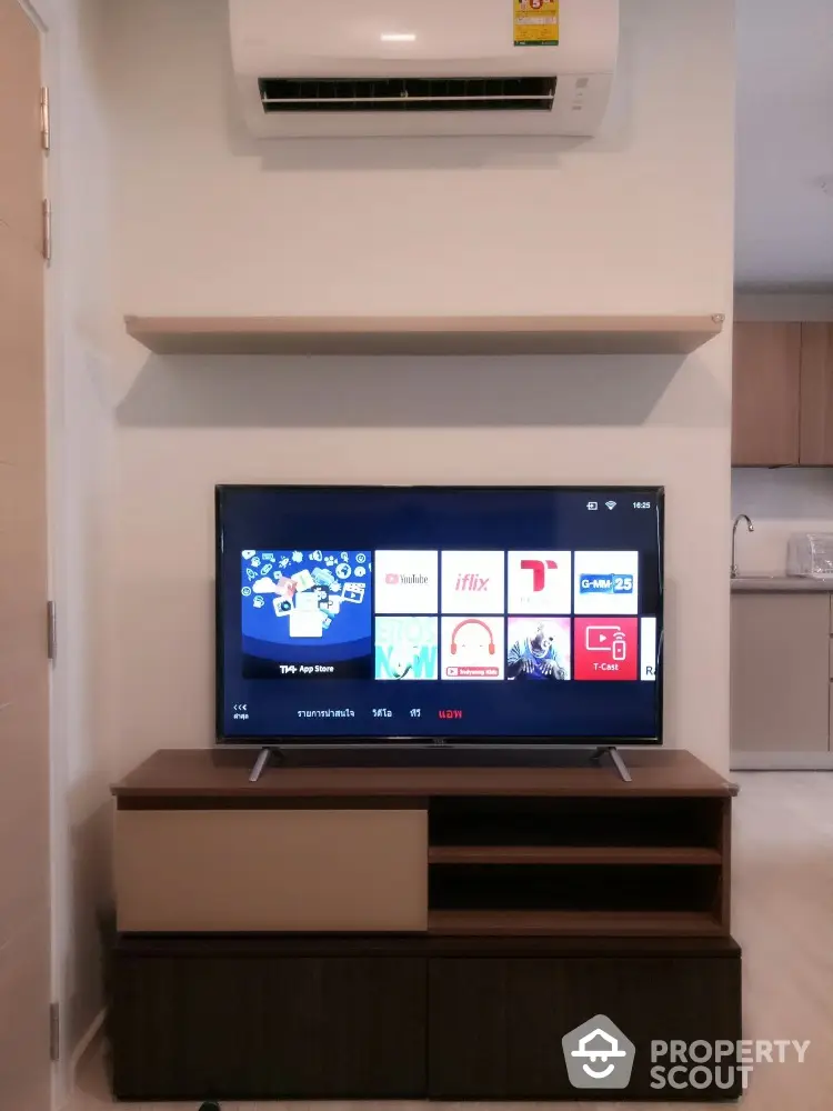 Modern living room with TV and air conditioning unit, sleek furniture design