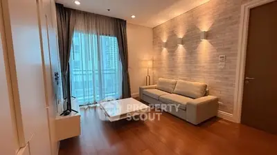 Modern living room with elegant lighting and wooden flooring in a high-rise apartment.