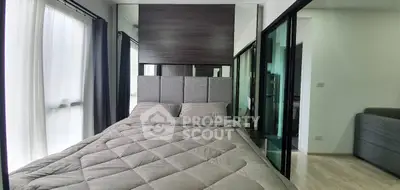 Modern bedroom with stylish decor and large windows for natural light.