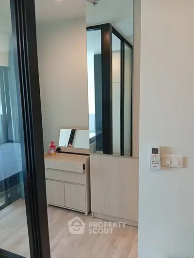 Modern bedroom with sleek wooden furniture and mirrored accents