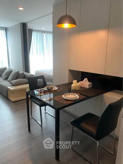 Modern open-plan living and dining area with stylish furniture and natural light.
