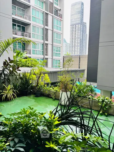 Modern urban apartment view with lush green balcony and cityscape backdrop