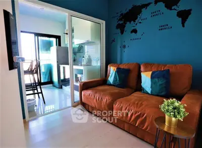 Modern living room with stylish decor and open kitchen layout in a cozy apartment.
