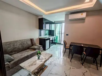 Modern living room with sleek design, featuring a cozy sofa, dining area, and a compact kitchen with city views.