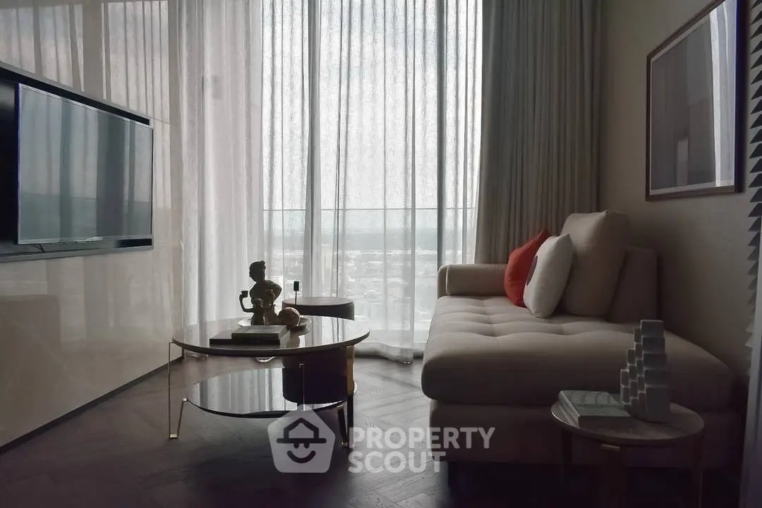 Luxurious living room with modern decor and large window offering stunning city views.