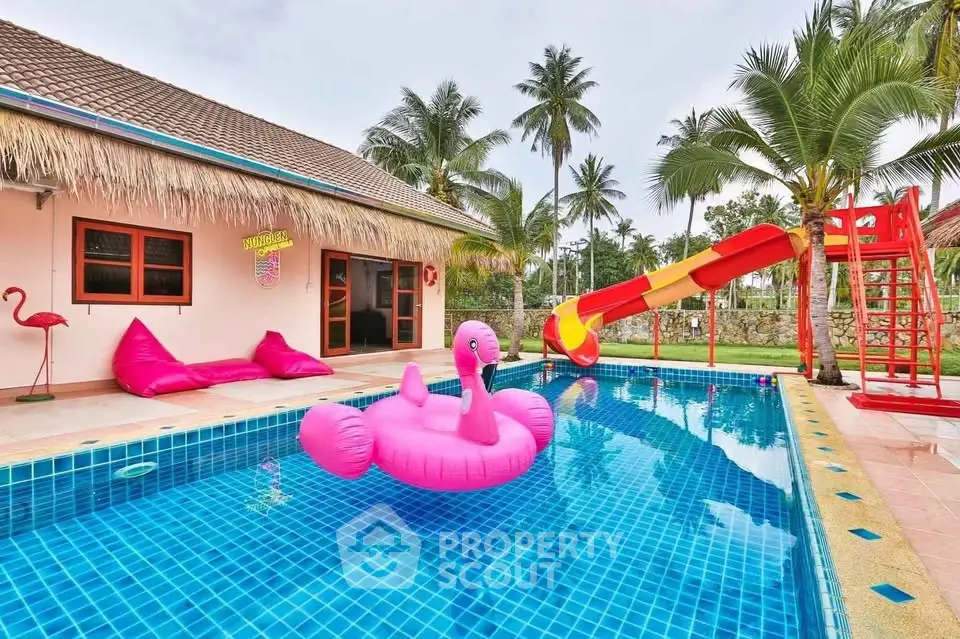 Tropical paradise pool with vibrant slide and flamingo float, perfect for family fun and relaxation.